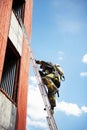 Firefighter climb on fire stairs Royalty Free Stock Photo