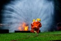 Firefighter Concept. Fireman using water and extinguisher to fighting with fire flame. firefighters fighting a fire with a hose an