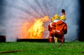 Firefighter Concept. Fireman using water and extinguisher to fighting with fire flame. firefighters fighting a fire with a hose an