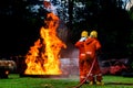 Firefighter Concept. Fireman using water and extinguisher to fighting with fire flame. firefighters fighting a fire with a hose an