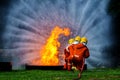 Firefighter Concept. Fireman using water and extinguisher to fighting with fire flame. firefighters fighting a fire with a hose an