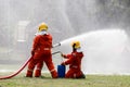 Firefighter Concept. Fireman using water and extinguisher to fighting with fire flame. firefighters fighting a fire with a hose an Royalty Free Stock Photo