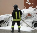 Firefighter and the covered car with white foam Royalty Free Stock Photo
