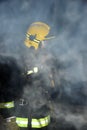 Firefighter in a dark and smoke filled building