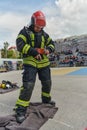 A firefighter dons the essential components of their professional gear, embodying resilience, commitment, and readiness Royalty Free Stock Photo