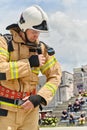A firefighter dons the essential components of their professional gear, embodying resilience, commitment, and readiness Royalty Free Stock Photo
