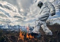 Firefighter ecologist in gas mask working in field with wildfire. Royalty Free Stock Photo