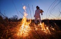 Firefighter ecologist working in field with wildfire. Royalty Free Stock Photo