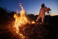 Firefighter ecologist working in field with wildfire. Royalty Free Stock Photo