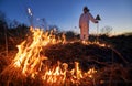 Firefighter ecologist working in field with wildfire. Royalty Free Stock Photo