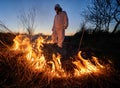 Firefighter ecologist working in field with wildfire. Royalty Free Stock Photo