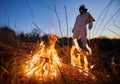 Firefighter ecologist working in field with wildfire. Royalty Free Stock Photo