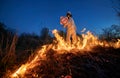 Firefighter ecologist working in field with wildfire. Royalty Free Stock Photo