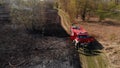 Firefighter engine extinguishing the burned meadow - wildfire - aerial shot