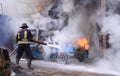 Firefighter extinguish a burning car