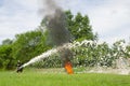 firefighter extinguish a burning smoking tire during demonstration performances