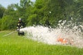 Firefighter extinguish a burning smoking tire point-blank during