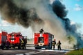 firefighter extinguishes a burning car after an accident Royalty Free Stock Photo