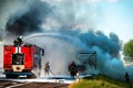 firefighter extinguishes a burning car after an accident Royalty Free Stock Photo
