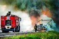 firefighter extinguishes a burning car after an accident Royalty Free Stock Photo