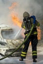 Firefighter extinguishes car fire