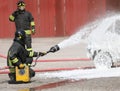 firefighter extinguishes a fire in a car