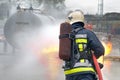 Firefighter extinguishing tank fire