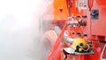 Firefighter fighting with flame using fire hose chemical water foam spray engine. Fireman wear hard hat, body safe suit uniform Royalty Free Stock Photo