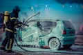 Firefighter - Firemen extinguishing a car with foam