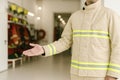 Firefighter gesturing toward fire station Royalty Free Stock Photo