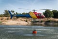 The firefighter helicopter filling the bucket at the lake