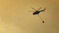 A firefighter helicopter rushes to help put out a wildfire