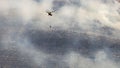 A firefighter helicopter rushes to help put out a wildfire