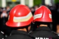 Firefighter helmets seen from behind during parade