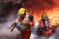 Firefighter holding child boy to save him in fire and smoke Firemen rescue the boys from fire