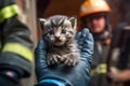 the firefighter is holding on hand a little kitten , he took him out of the fire. Generative AI