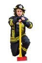 Firefighter holds axe and kneeling isolated on white background Royalty Free Stock Photo