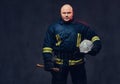 Firefighter holds the axe. Royalty Free Stock Photo