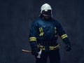 Firefighter holds the axe. Royalty Free Stock Photo