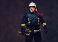 Firefighter holds the axe. Royalty Free Stock Photo