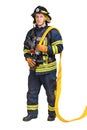 firefighter holds fire hose with fire nozzle in hands and looking at camera Royalty Free Stock Photo