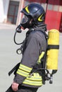 Firefighter with large yellow oxygen cylinder and protective hel Royalty Free Stock Photo