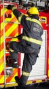 Firefighter, man and climbing ladder for emergency operation, service or rescue with equipment. Fireman person with