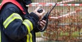 Firefighter operate with a walkie talkie in action - Serie Firefighter Royalty Free Stock Photo