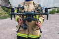 Firefighter operating drone in search and rescue