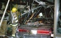 Firefighter pouring water inside a Mc Donalds after a car drove through causing a fire