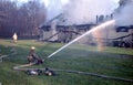 Firefighter pour water on a building on fire