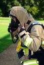 Firefighter prepares his breathing apparatus at fire scene Royalty Free Stock Photo