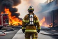 Firefighter in protective gear standing in front of a burning building Royalty Free Stock Photo