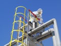 A firefighter in a protective suit closes the valve on the pipeline in an emergency.